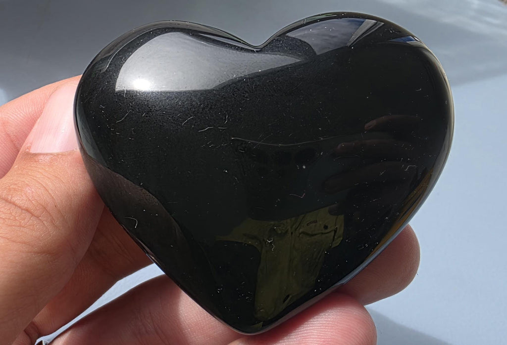 Polished green flash rainbow obsidian heart palm stone