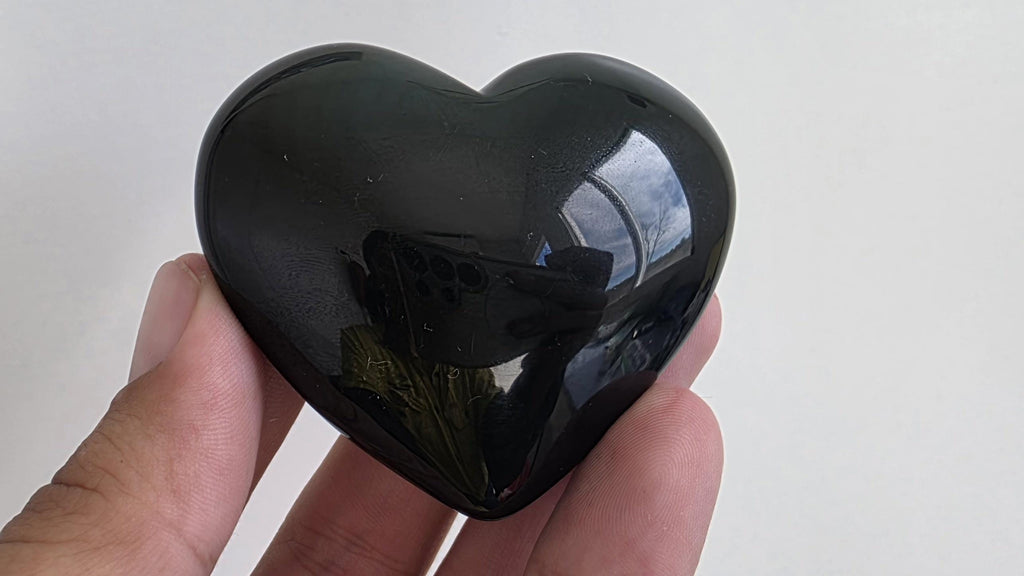 Polished green flash rainbow obsidian heart palm stone