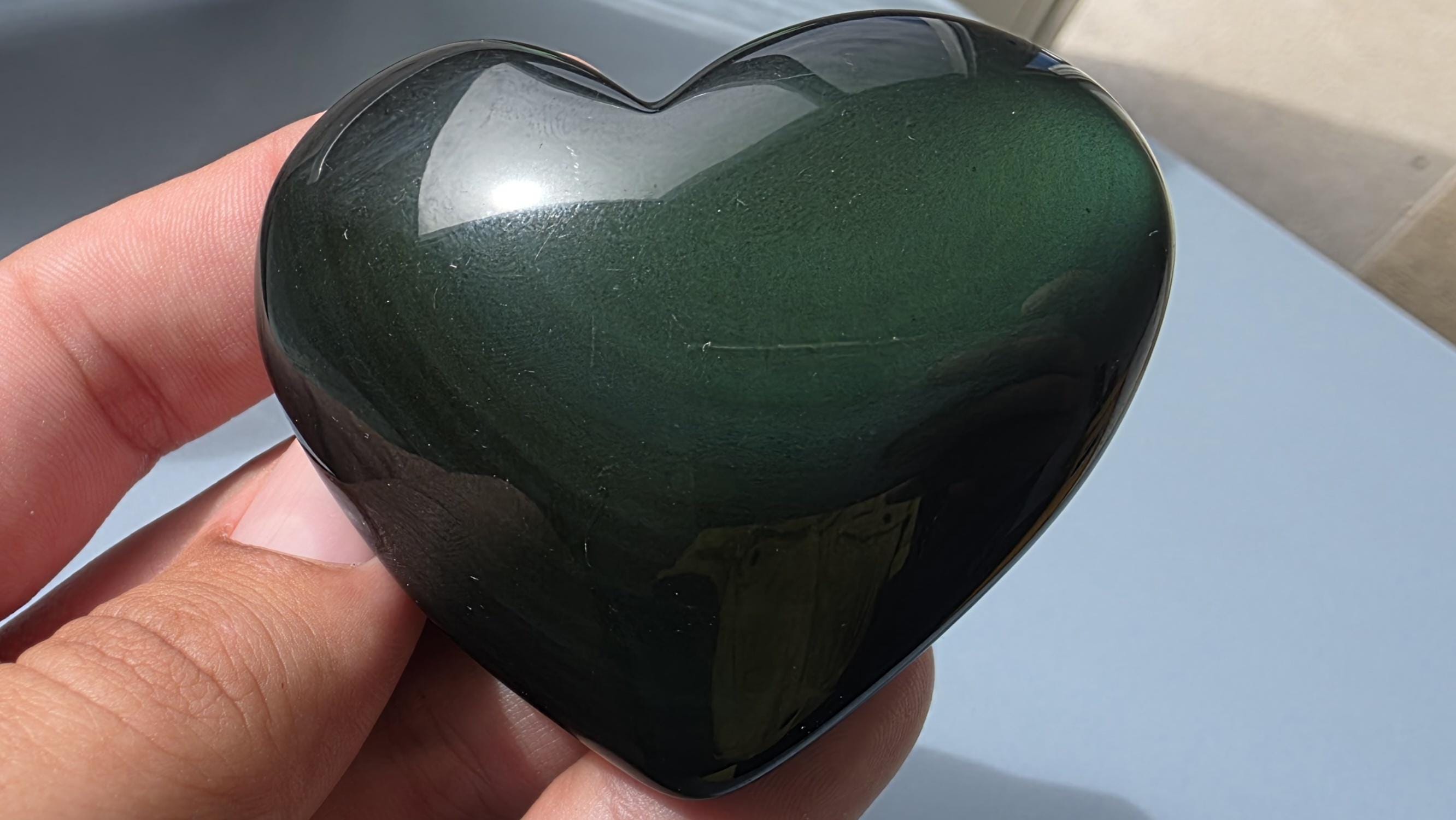 Polished green flash rainbow obsidian heart palm stone